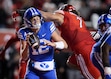 (Bethany Baker  |  The Salt Lake Tribune) Brigham Young Cougars quarterback Jake Retzlaff (12) avoids a tackle from Utah Utes defensive end Van Fillinger (7) during the game between the Utah Utes and the Brigham Young Cougars at Rice-Eccles Stadium in Salt Lake City on Sunday, Nov. 10, 2024.